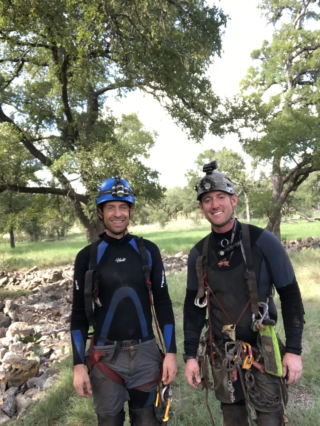 Two men wearing wetsuits and other gear